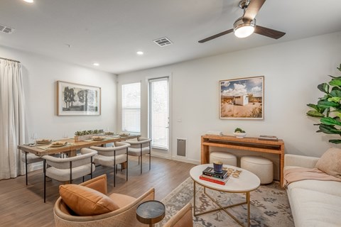 A living room with a dining table and chairs.